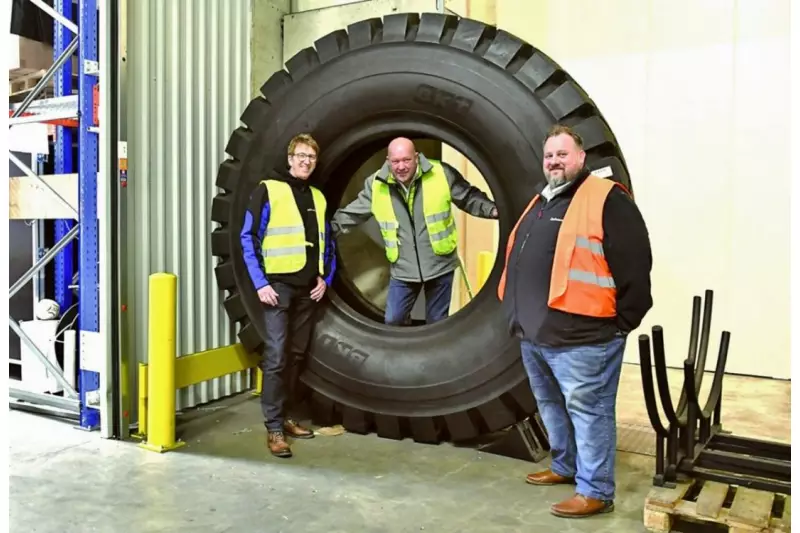 Einer von BKTs Größten mit fast 1,5 t. Derzeit absolviert der Monsterreifen für Muldenkipper Praxistests in Deutschland. Mit auf dem Bild: Henrik Schmudde (l.) Marketingleiter Bohnenkamp, Frank Hörsting (r.), Markenmanager BKT bei Bohnenkamp, und Manfred Zwick von Treffpunkt.Bau.