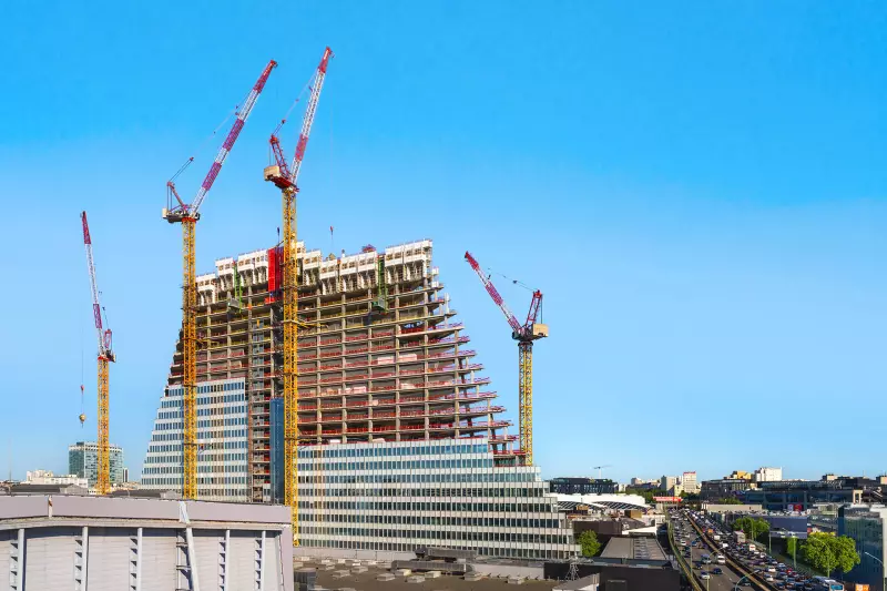 Zwei der vier Liebherr 280 HC-L Verstellauslegerkrane stehen auf Portalen und wachsen außen am Gebäude mit hoch.