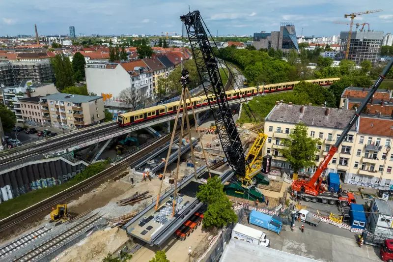 Die zweite Eisenbahnbrücke wird bei laufendem S-Bahnbetrieb am Nachbargleis montiert.