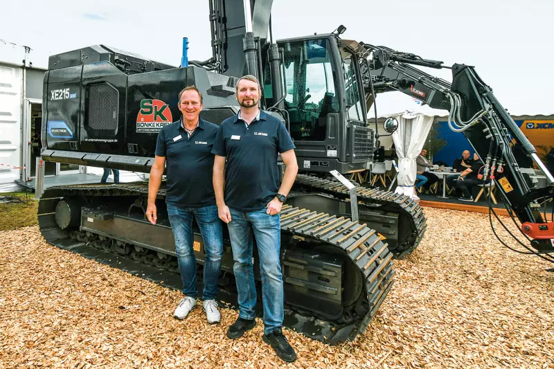 Elektro boomt – wenn man mit chinesischen Herstellern spricht. XCMG sieht sich in führender Position bei schweren E-Baumaschinen und will diese weiter ausbauen. Dr. Dirk Sträter (l.) und Wilhelm Laven informierten uns über den an europäische Ansprüche angepassten XE215EV mit 23,5 t. Quelle: Treffpunkt.Bau