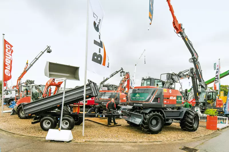 Spannendes Gespann bei Atlas von der Wehl. Der 16, 5 t schwere Atlas 155W Bigfoot mit bodenschonenden Niederdruckreifen war mit einem 4.000 mm Mera Rabeler Mähkorb mit Klappeinrichtung und 90°-Schwenkkopf ausgerüstet. Hinten am Haken hing ein 2-Achs-Kipper. Quelle: Treffpunkt.Bau