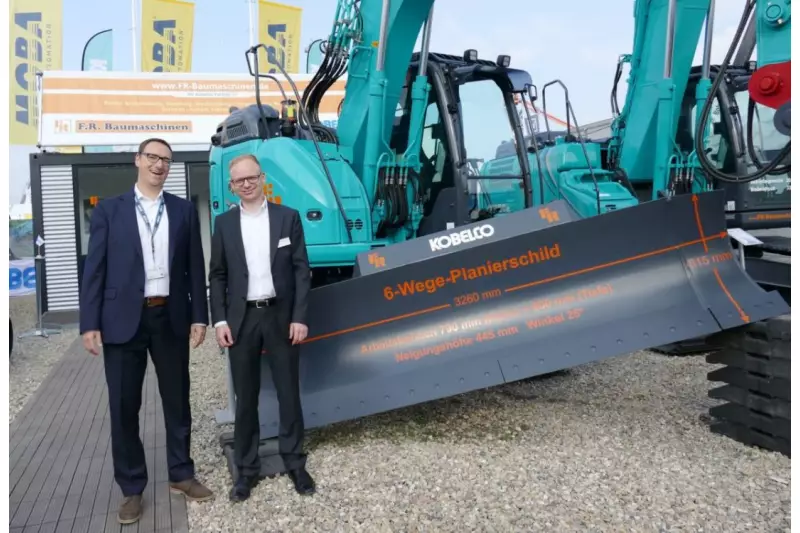 Von wegen „nordisch unterkühlt“. Herzlich willkommen fühlte sich jeder Besucher beim Team von F.R. Baumaschinen/Kobelco. Hanns Markus Renz (l.), Business Manager Kobelco Europe, und Sebastian Teschke, Geschäftsführer F.R. Baumaschinen, zeigten uns das Multitalent ED 160-5 Blade Runner mit 6-Wege-Schild.