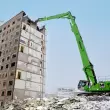 Der SENNEBOGEN 870 E Demolition Longfront Bagger gewährleistete den sicheren und präzisen Rückbau des innerstädtischen Plattenbaus.