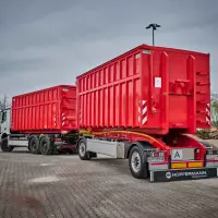 Neue Ausführung des 2-Achs-Schlitten-Carrier für den Transport von Abrollcontainer.